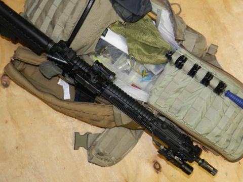 1996 Ford Bronco - Tactical rifle and gear laid out on a wooden surface, with a Supermotors.net watermark visible.