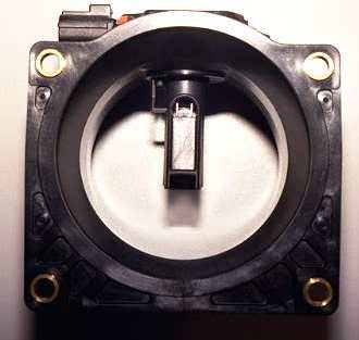 1998 Ford Crown Victoria - End-on view of a square black mass air flow sensor housing with the internal sensor element and electrical connector visible.