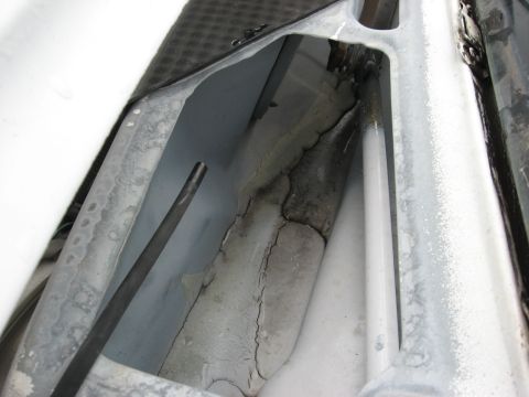 1994 Ford Bronco - Interior view shows damaged plastic trim and exposed metal components.