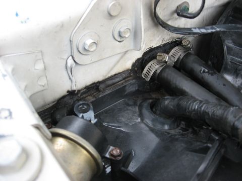 1994 Ford Bronco - This image shows a section of a vehicle's engine bay with hoses and sealant.