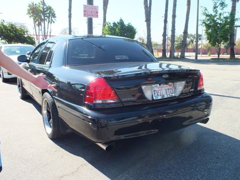 2003 Ford Crown Victoria - Rear-quarter shot of a lowered black Crown Victoria with the EVIL VIC California plate.