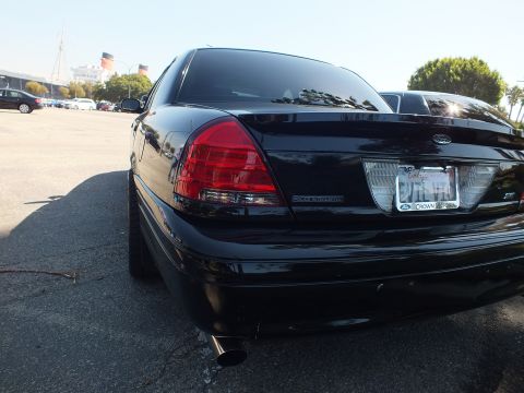 2003 Ford Crown Victoria - Rear-corner view of a black Crown Victoria Police Interceptor showing one exhaust outlet.
