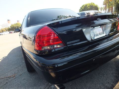 2003 Ford Crown Victoria - Rear-quarter shot of a black Crown Victoria Police Interceptor at an outdoor meet.