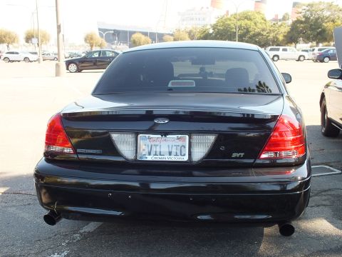 2003 Ford Crown Victoria - Straight-on rear of a black Crown Victoria SVT showing EVIL VIC plate and dual tips.
