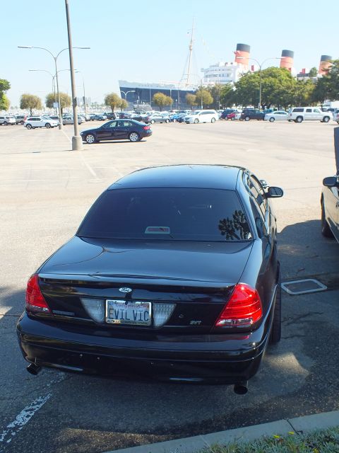 2003 Ford Crown Victoria - Tall rear view of a black Crown Victoria SVT with EVIL VIC plate and the Queen Mary.