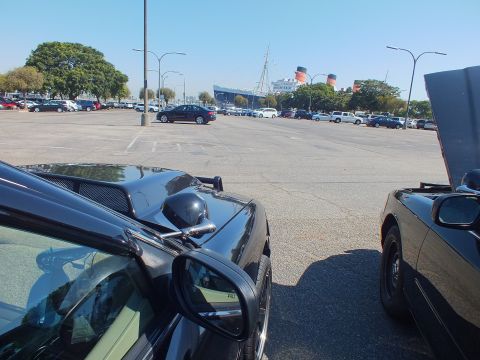 2003 Ford Crown Victoria - View across an open lot framed by car mirrors, with the Queen Mary ship beyond.