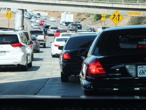 2003 Ford Crown Victoria - Bumper-to-bumper highway congestion seen behind a black sedan trunk