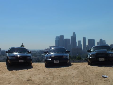 2003 Ford Crown Victoria - Trio of black sedans lined up on a hilltop overlooking downtown Los Angeles