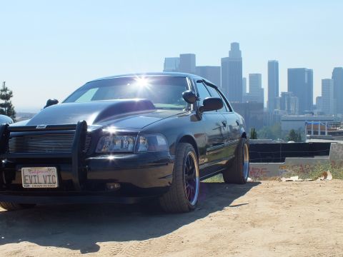 2003 Ford Crown Victoria - Front-quarter view of a modified black Crown Victoria on a hilltop lot