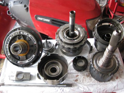 1994 Ford Bronco - Another View of the Parts. From left to right (Top): Pump assembly Overdrive servo assembly intermediate band Intermediate clutches / rever…