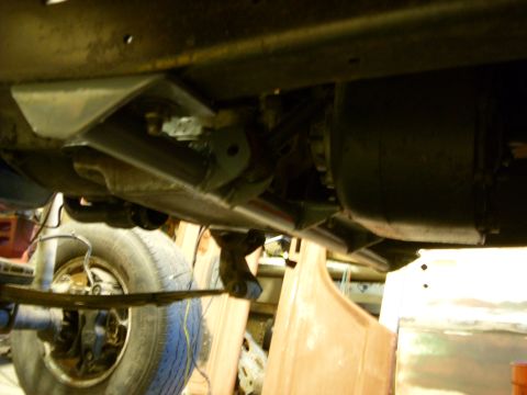1967 Ford F-250 - Close-up of the undercarriage, focusing on the suspension and leaf spring assembly of a truck.