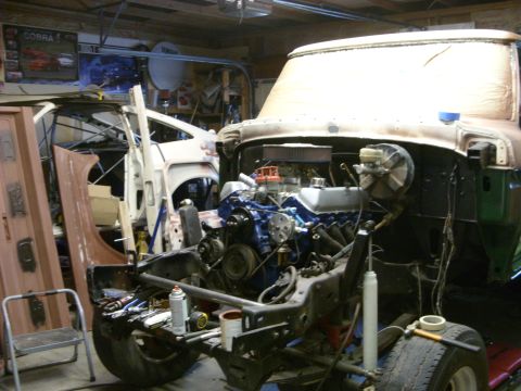 1967 Ford F-250 - Garage scene shows a 1967 Ford F-250 chassis with its engine, and another vehicle in the background.
