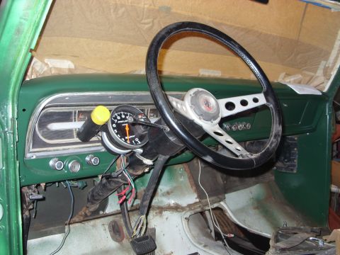 1967 Ford F-250 - Interior view of a 1967 Ford F-250 cab, a green dashboard and an added tachometer.