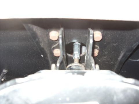 1967 Ford F-250 - A close-up view of a vehicle's brake system components, including bolts and metal brackets.