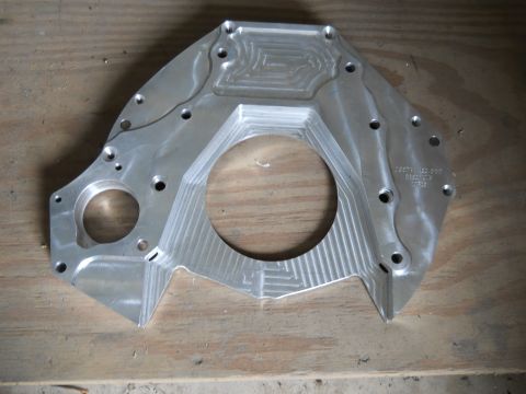 1992 Ford Bronco - This machined aluminum adapter plate features intricate grooving and multiple mounting points.