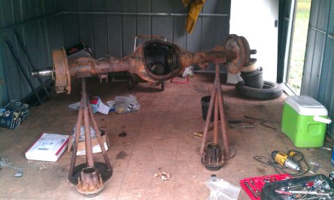 1995 Ford Bronco - A disassembled rear axle assembly is shown on stands, suggesting it is undergoing repair or maintenance.