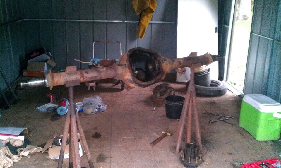 Rear axle assembly on stands in shed