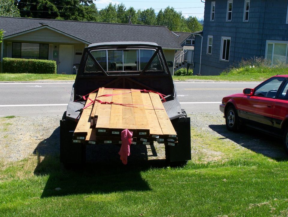 Pickup truck bed loaded with lumber, rear view