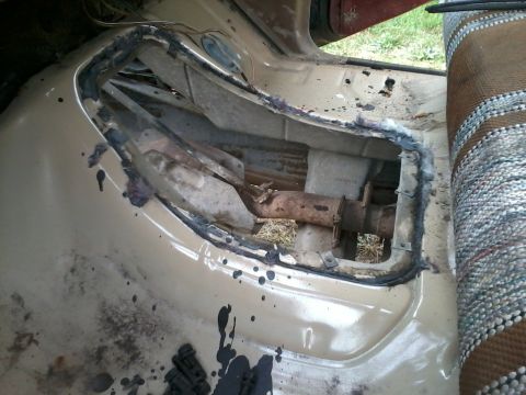 1981 Ford Bronco - This photo shows the interior floor of a vehicle, with a section cut out to expose the transmission tunnel and driveshaft.