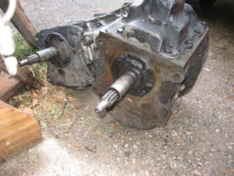 1981 Ford Bronco - Two manual transmissions, likely for a swap, are shown resting on the ground outdoors.