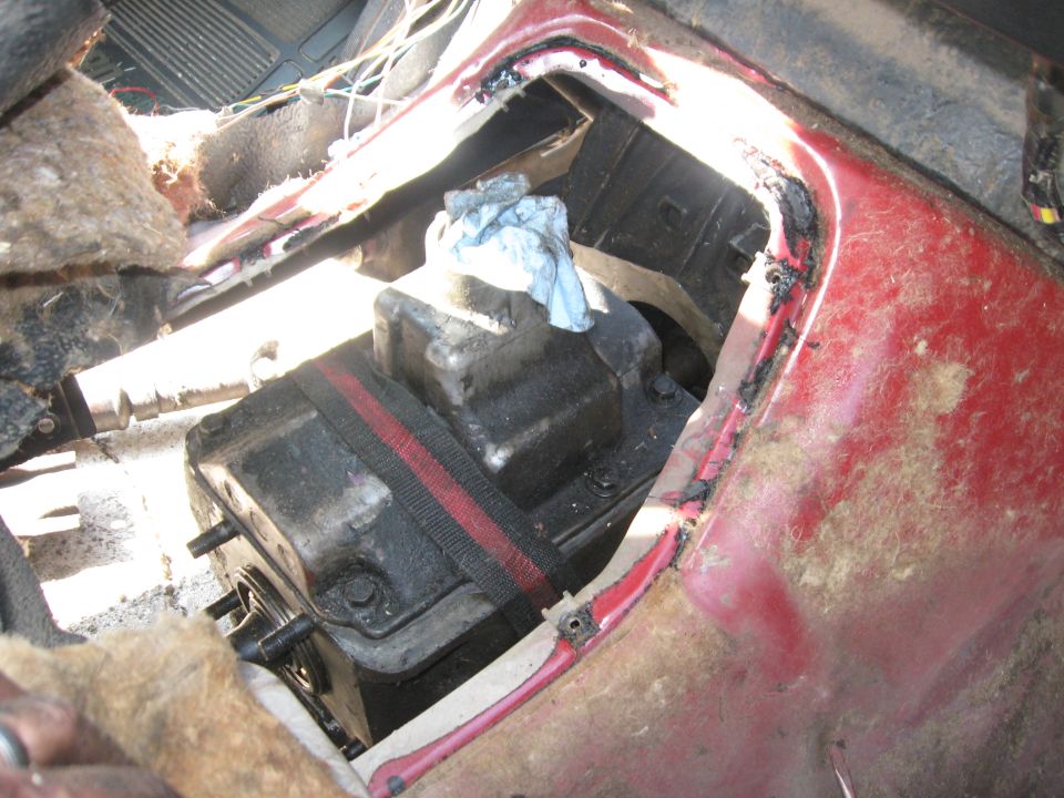 The transmission wouldn't fully go into place with the floor pan on, so I had to switch jobs for a few, pull up the floor mat and remove the pan.  The NP435 is tall, and the shifter goes *through* the opening in the floor pan and the SROD pan didn't have that opening.

After the pan was removed, the transmission sat in nicely.