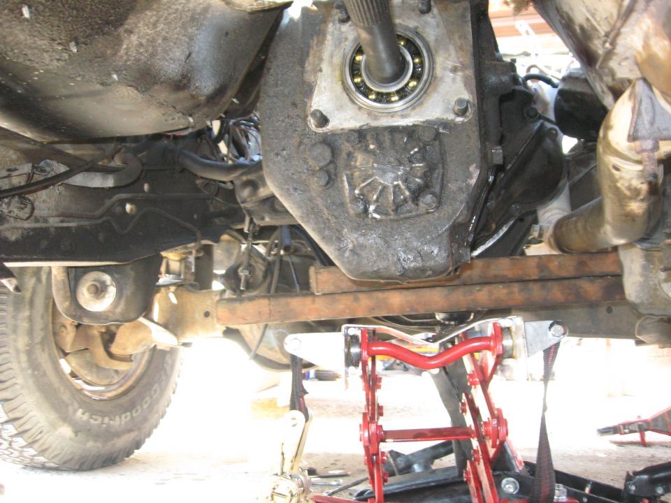 Transmission bolted to the engine and hanging on its own strength.

A little deceiving in this picture because, no, the blocks of wood are not under the transmission, and they're not on top of the transmission jack.