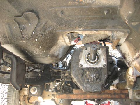 1981 Ford Bronco - Transmission and drivetrain parts visible from underneath a vehicle.