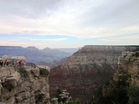 1991 Ford LTD Crown Victoria - View of the Grand Canyon from a scenic overlook with several people observing the landscape.