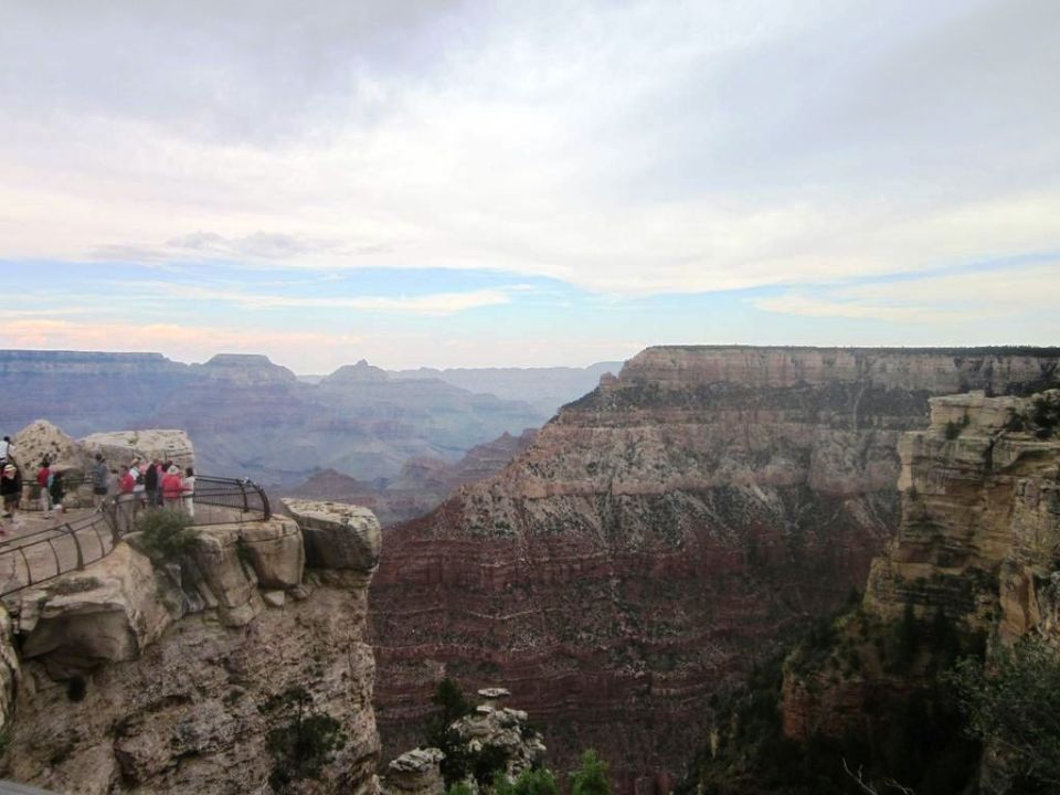 Tourists on a viewpoint overlooking the Grand Canyon