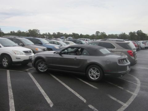 1991 Ford LTD Crown Victoria - Gray convertible parked in a lot with other vehicles around.