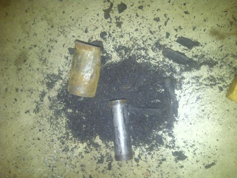 1995 Ford Bronco - Metal pipe fragments and debris on a concrete floor.