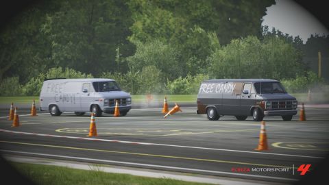 2000 Mercury Grand Marquis - Two vans, one white and one dark gray, are driving on a track with orange cones, each displaying "free candy" text.