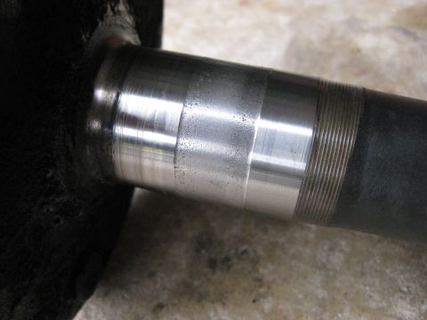 1994 Ford Bronco - This is a close-up view of a vehicle's rear axle shaft, showing wear marks and machined surfaces.