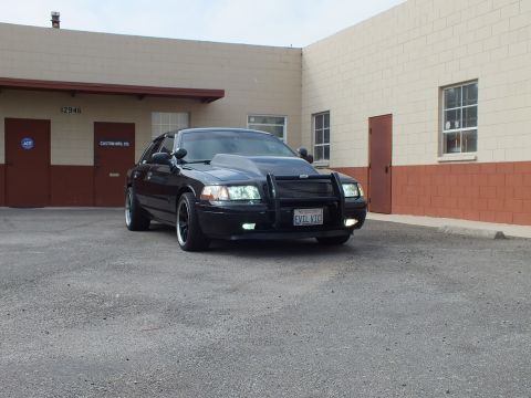 2003 Ford Crown Victoria - Three-quarter angle of the Crown Victoria with cowl hood, push bar and EVIL VIC plate.