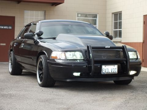 2003 Ford Crown Victoria - Low and black, this Crown Victoria shows its push bar, cowl hood and EVIL VIC plate up close.