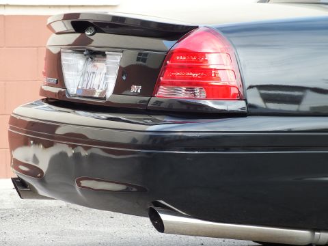 2003 Ford Crown Victoria - Rear detail with the EVIL VIC license plate, SVT trunk badge and polished exhaust tip.