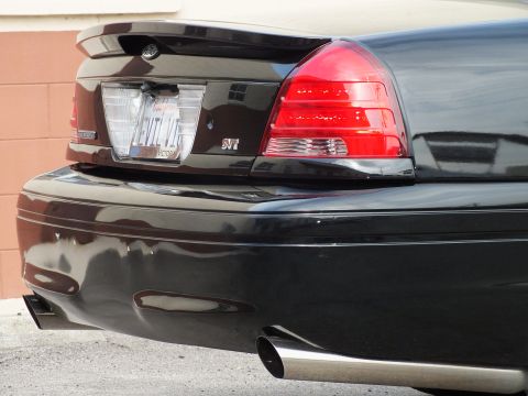 2003 Ford Crown Victoria - Rear detail showing the EVIL VIC plate, SVT trunk emblem, taillight and exhaust tip.