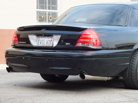 2003 Ford Crown Victoria - Rear-bumper detail with Crown Victoria plate frame, EVIL VIC plate and twin chrome exhaust tips.