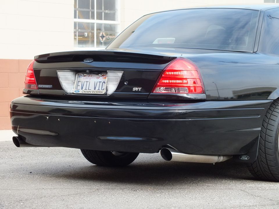 Close-up of black Crown Victoria rear bumper, EVIL VIC plate, SVT badge and dual exhaust