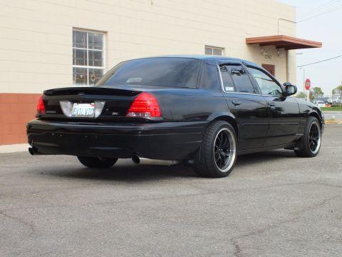 2003 Ford Crown Victoria - Lowered black Crown Victoria rear quarter showing SVT badge, EVIL VIC plate and dual exhaust
