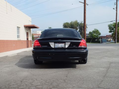 2003 Ford Crown Victoria - Straight rear shot of lowered black Crown Victoria with EVIL VIC plate and SVT badge