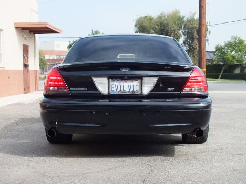 2003 Ford Crown Victoria - Rear of a black Crown Victoria showing trunk badging, EVIL VIC plate and dual tailpipes