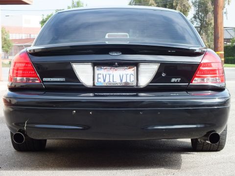 2003 Ford Crown Victoria - Dead-rear view of lowered black Crown Victoria, SVT badge and chrome dual exhaust