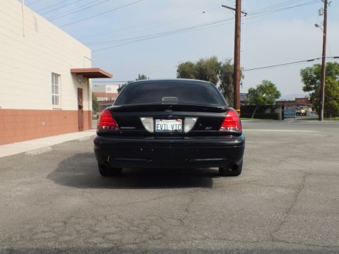 2003 Ford Crown Victoria - Rear view of lowered black Crown Victoria with EVIL VIC plate and dual exhaust