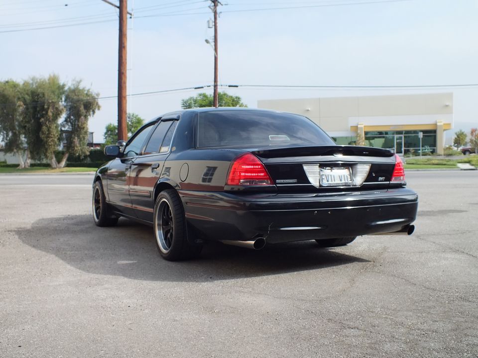 Black Crown Victoria SVT left rear quarter, black wheels, pinstripe side trim
