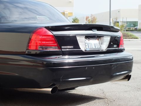 2003 Ford Crown Victoria - Close rear view of black Crown Victoria trunk, SVT badge, EVIL VIC plate and exhaust