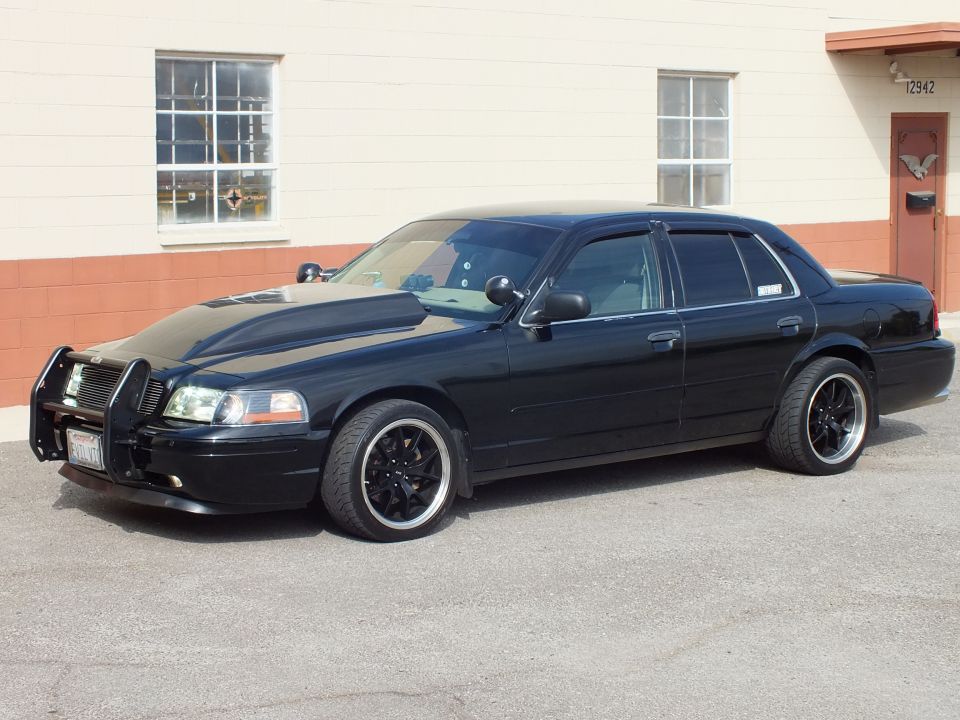 Black Crown Victoria front three-quarter, push-bar guard, black wheels by building