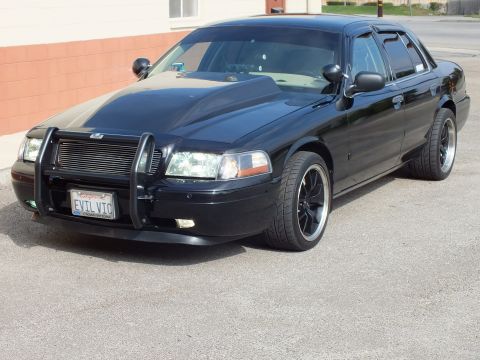 2003 Ford Crown Victoria - Front quarter of black Crown Victoria with grille guard, billet grille and EVIL VIC front plate