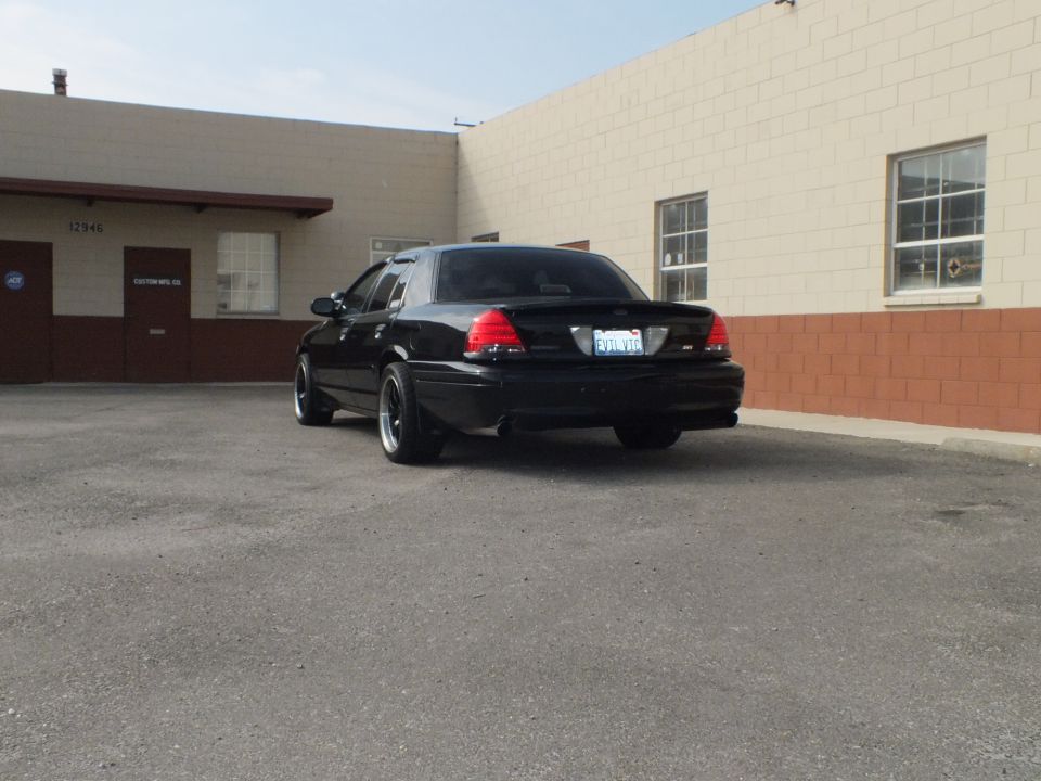 Black Ford Crown Victoria rear three-quarter, SVT badge, lip spoiler, black wheels
