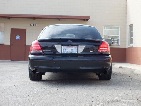 2003 Ford Crown Victoria - Rear view of a black Ford Crown Victoria SVT showing dual exhaust and a California EVIL VIC plate.